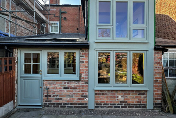 green casement windows and a stable door
