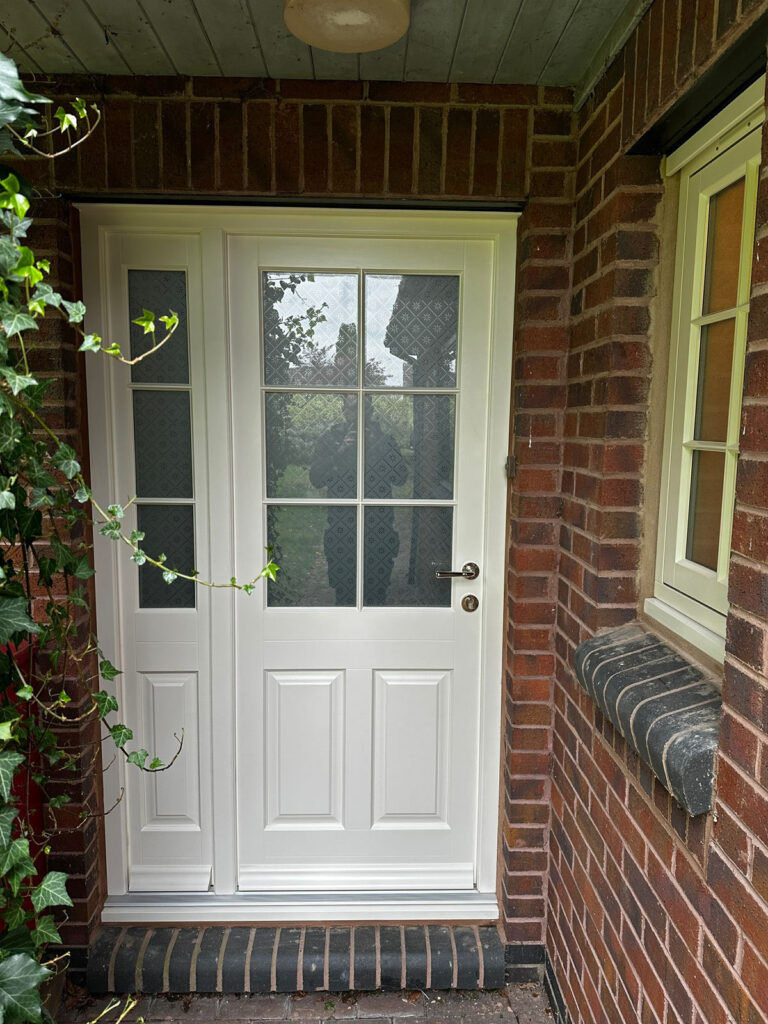 Cream timber front door with a sidelight