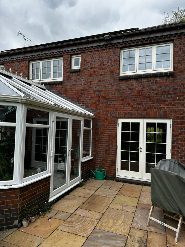 a conservatory at the read of a home with new timber french doors