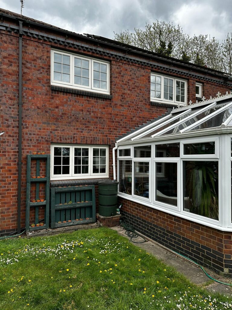 cream coloured casement windows and a conservatory