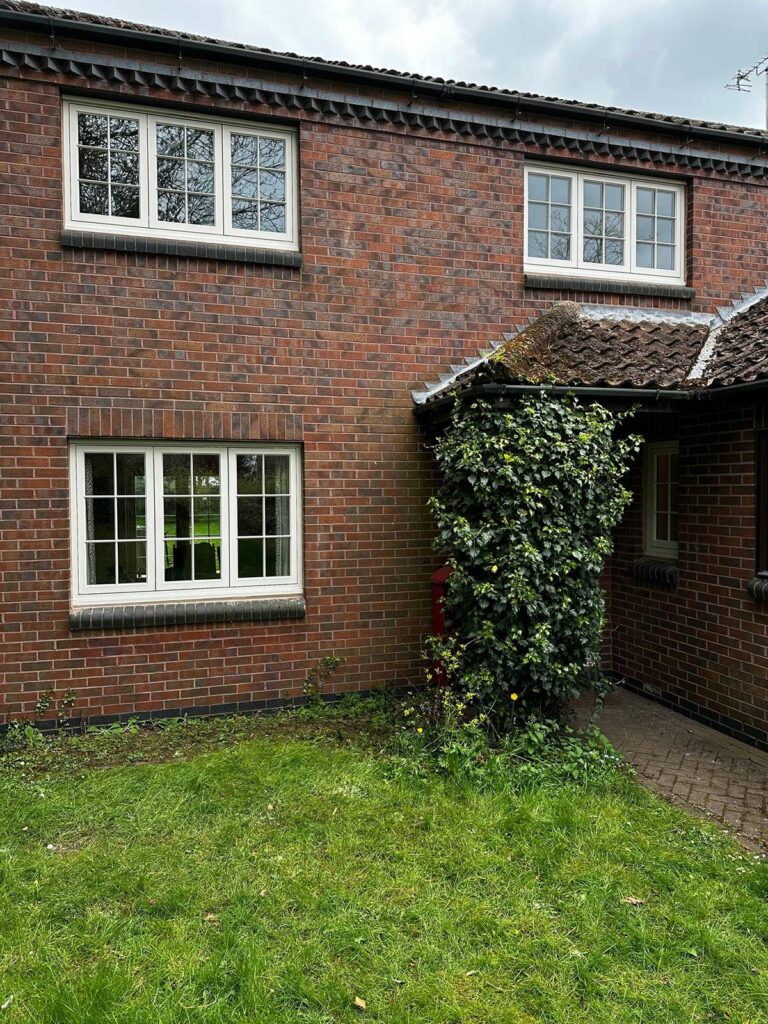 new cream coloured casement windows on a red brick home