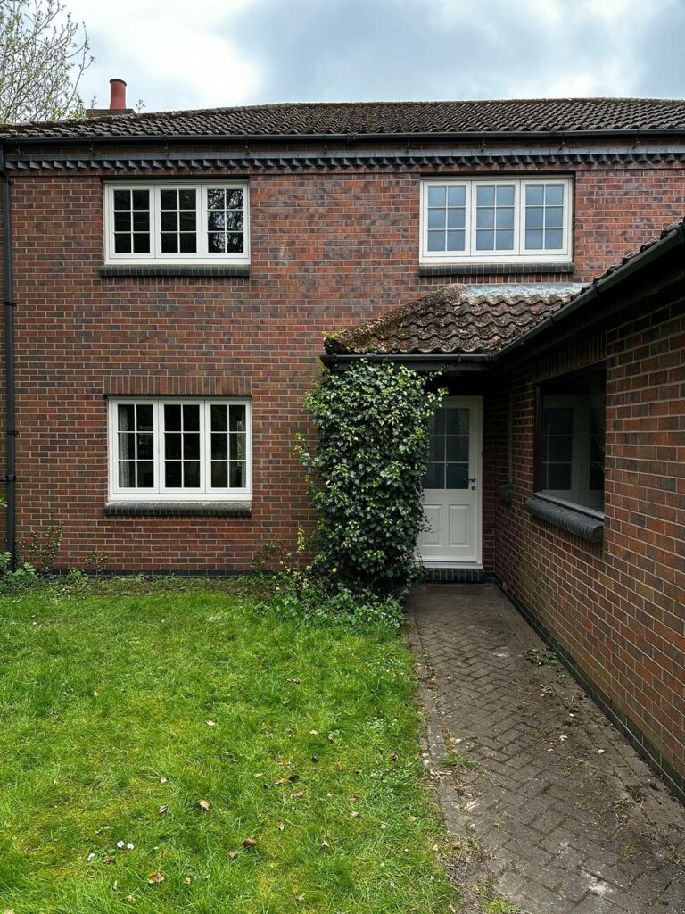 new cream coloured casement windows on a red brick home