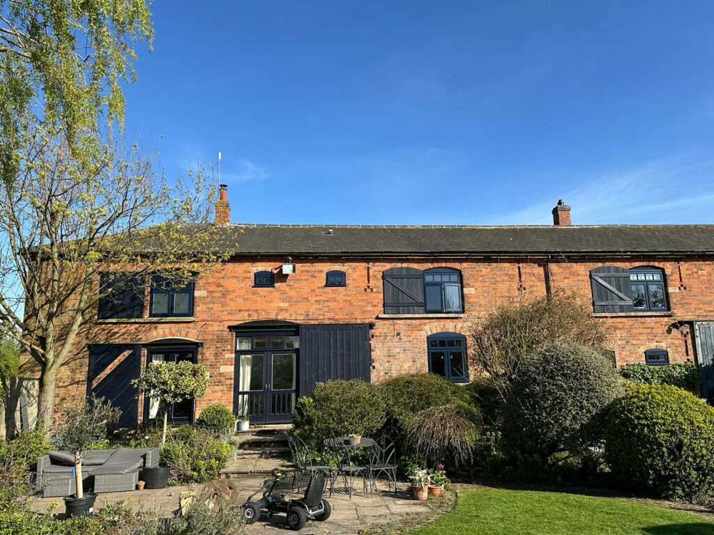 a converted barn with new lipped casement windows in oxford blue