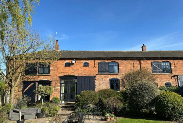 a converted barn with new lipped casement windows in oxford blue
