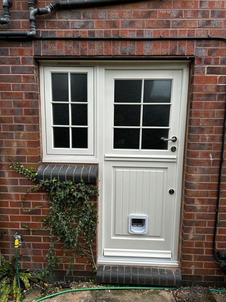 a cream stable door with a white cat flap and a flag window
