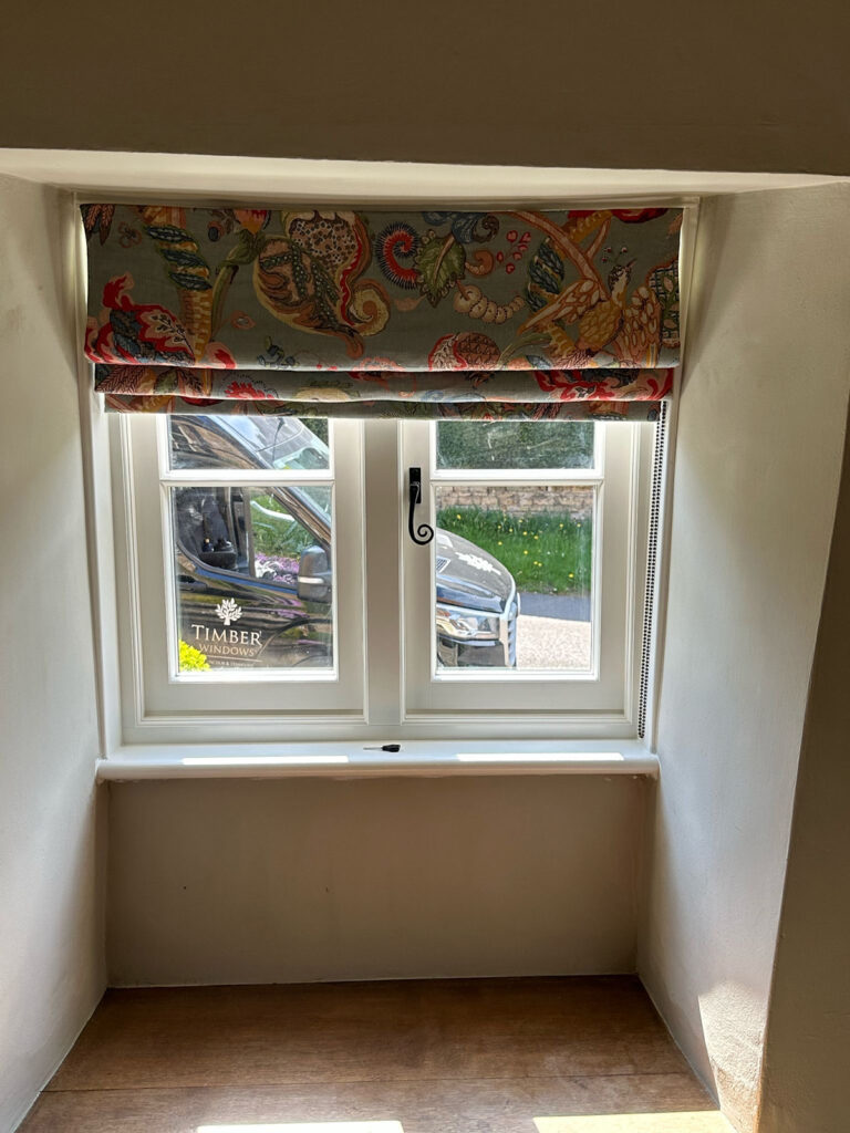 a set of white windows with a monkeytail handle
