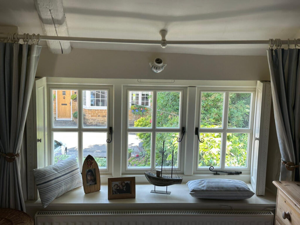 triple set of white windows with monkeytail handles