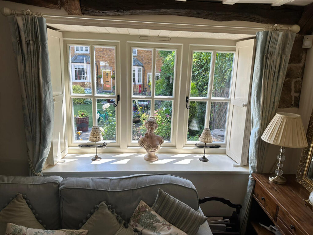 triple set of white windows with monkeytail handles