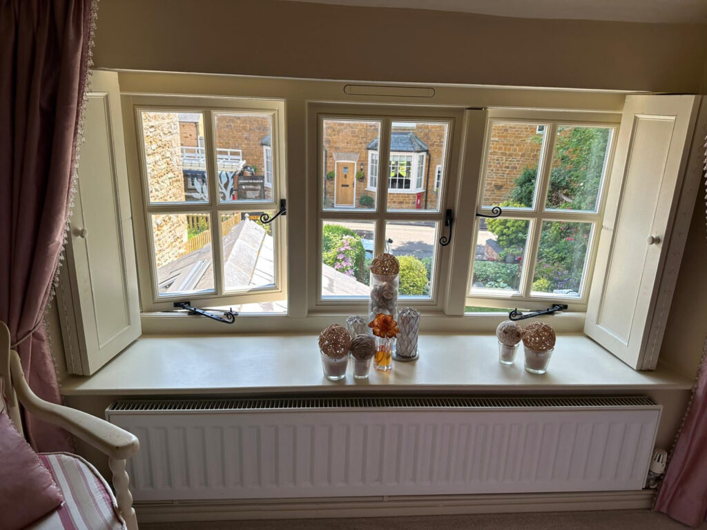 triple set of white windows with monkeytail handles