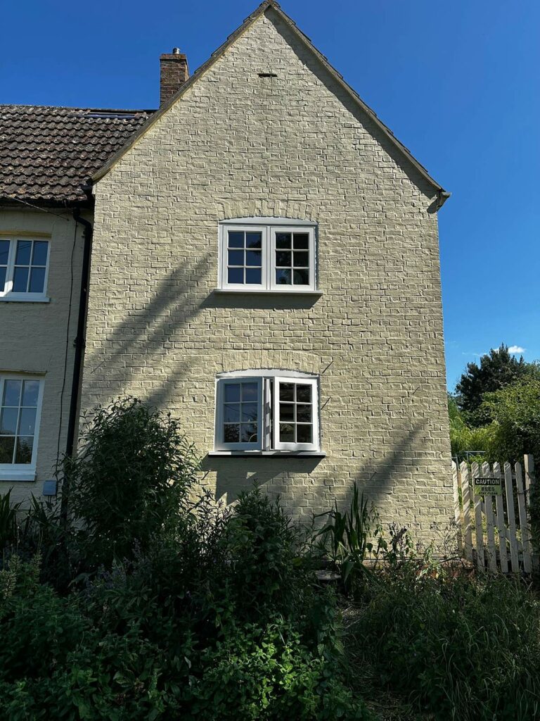 two sets of casement windows on the side of a building