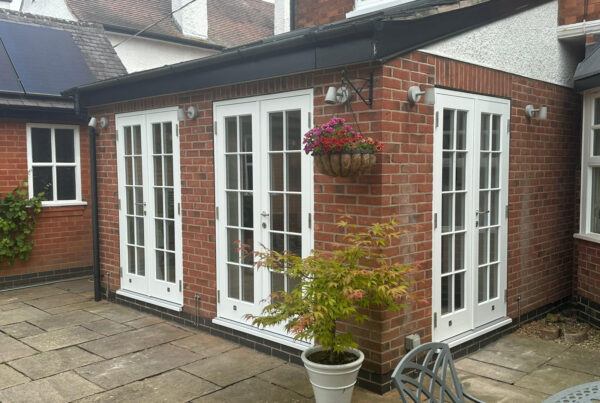 3 sets of white french doors at the rear of a property