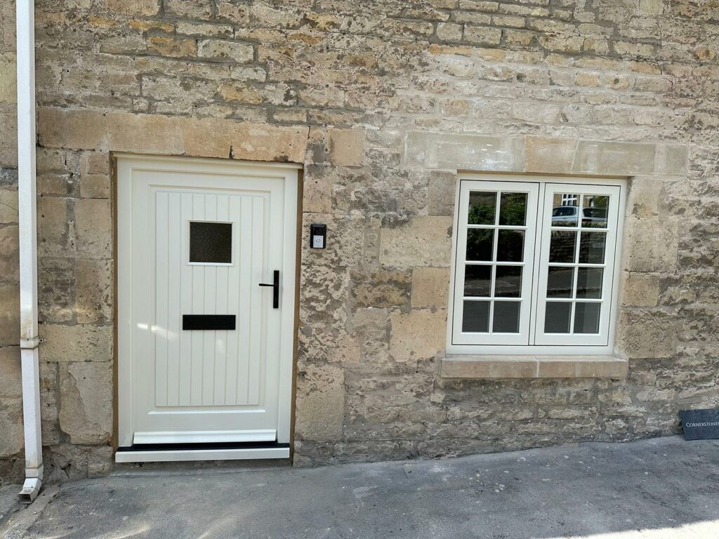 a white front door and georgian casement window