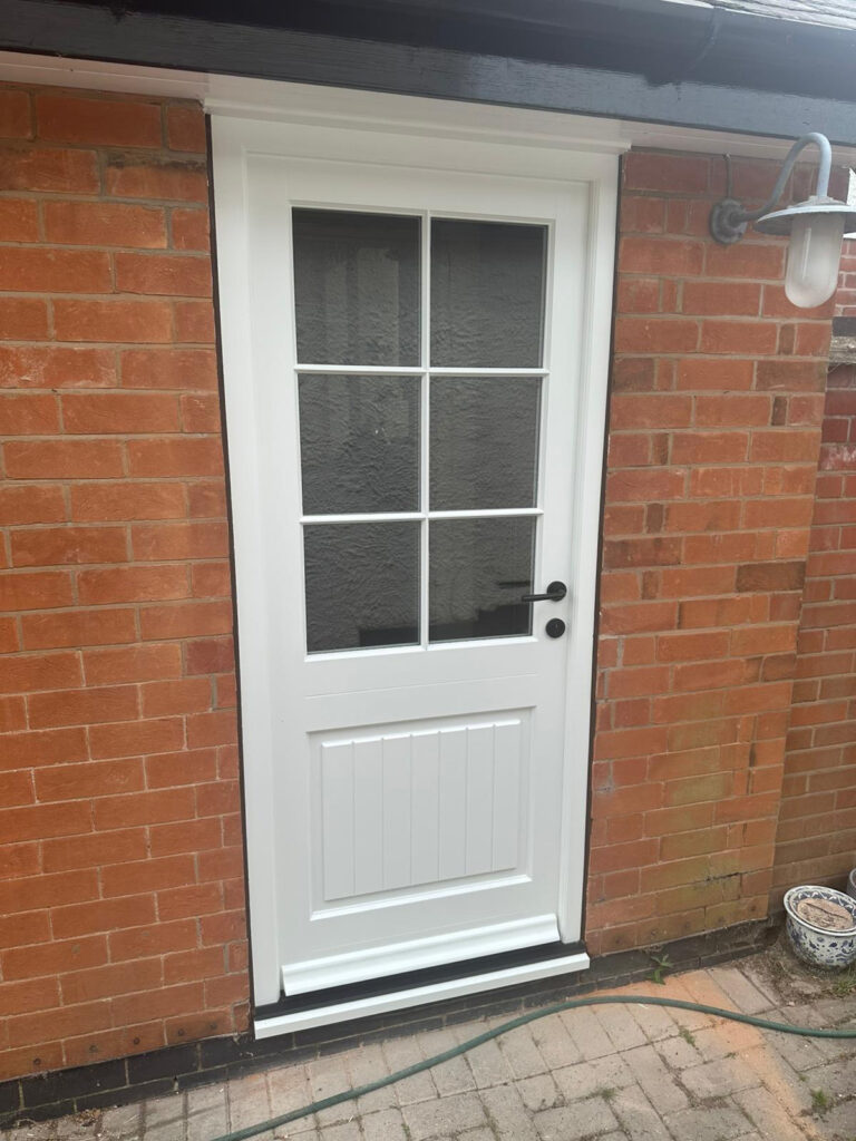 a white back door with glazing bars