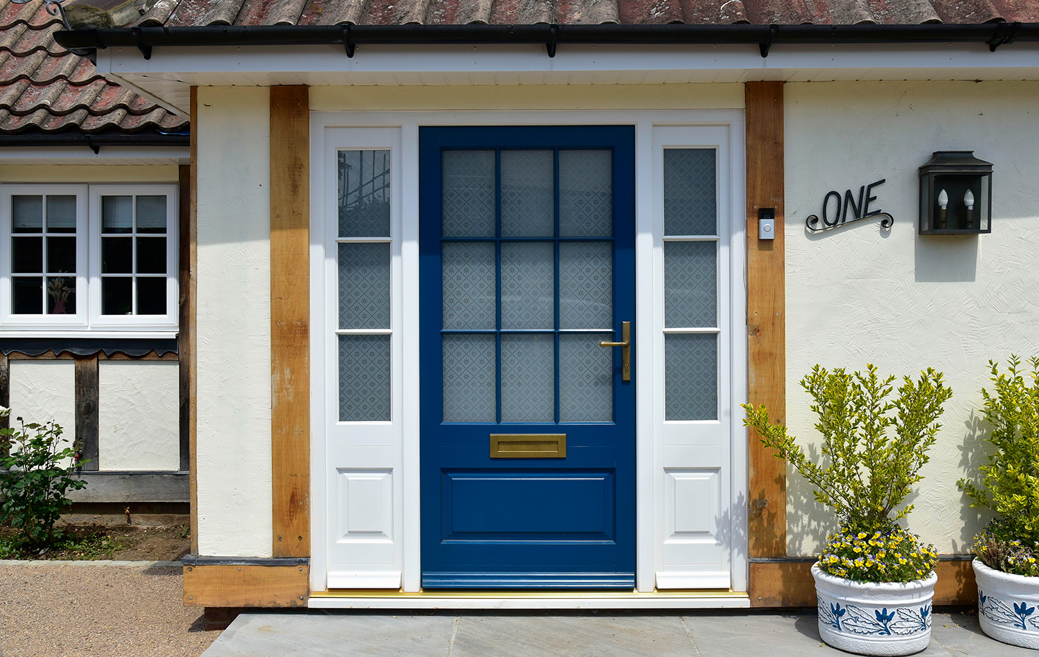 a blue front door with white sidelights