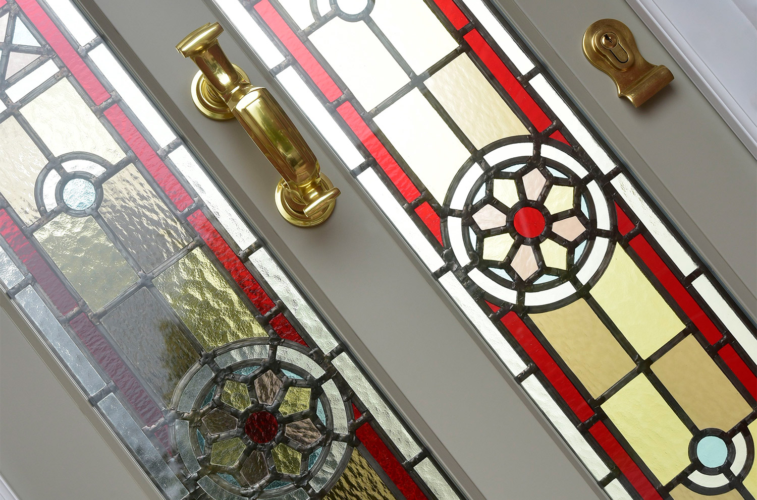 a door with stained glass and brass hardware