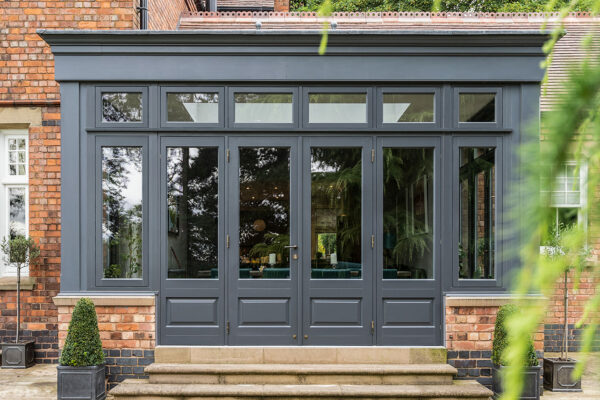an impressive, dark set of french doors with sidelights at the rear of a property.