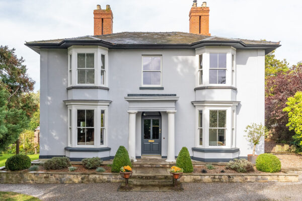 a beautiful large manor house with victorian sash windows