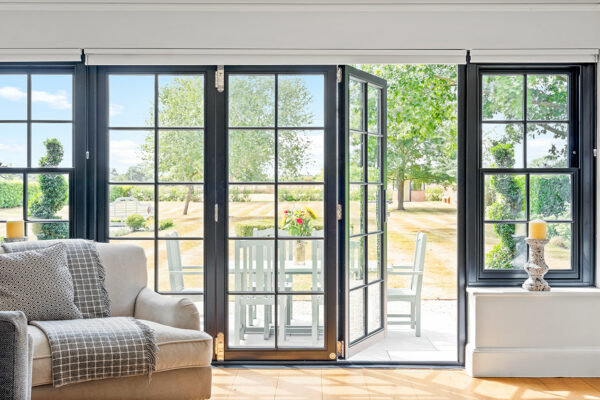 a black set of bifold doors and sash windows