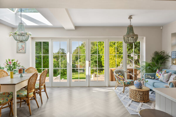 a large set of timber french doors with sidelights in a property sun room