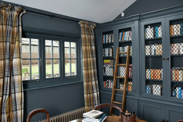 a dark coloured library with matching windows