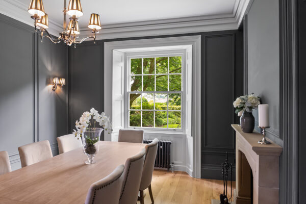 a stylish, modern dining room with a georgian sash window