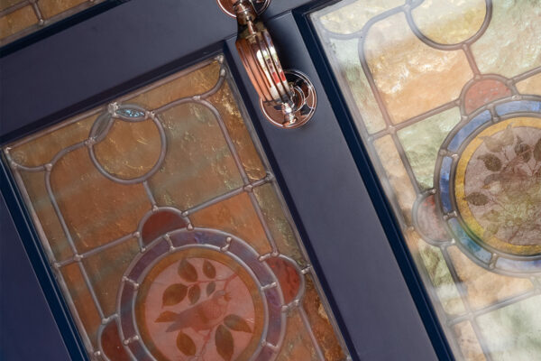 a blue front door with a bespoke stained glass pattern