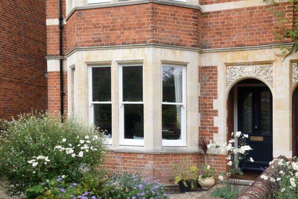 victorian sash windows on a red brick townhouse