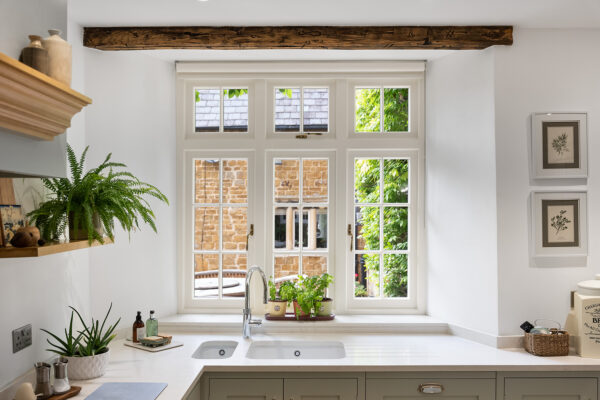 a country kitchen with white windows