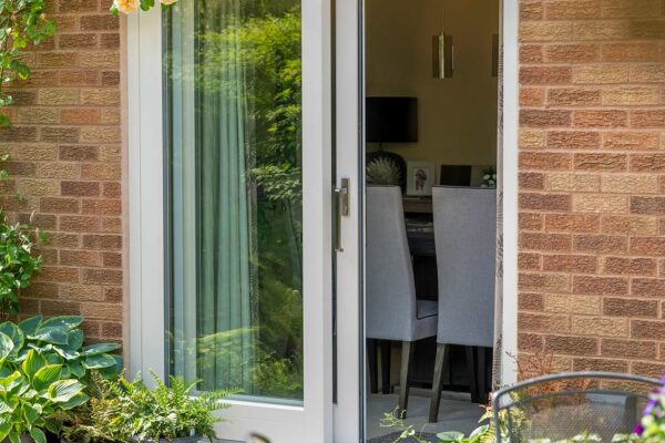 a white set of patio doors partially opened