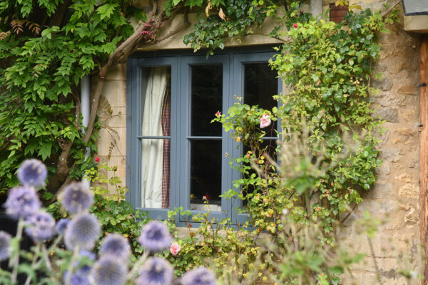blue flush casement windows on a stone cottage