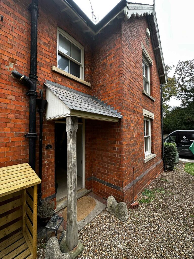 a red brick detached home with white sash windows