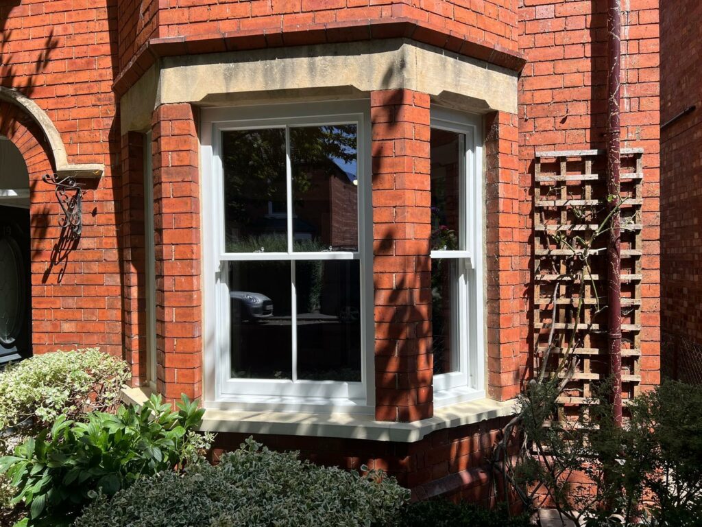 a red brick townhouse with white sash windows