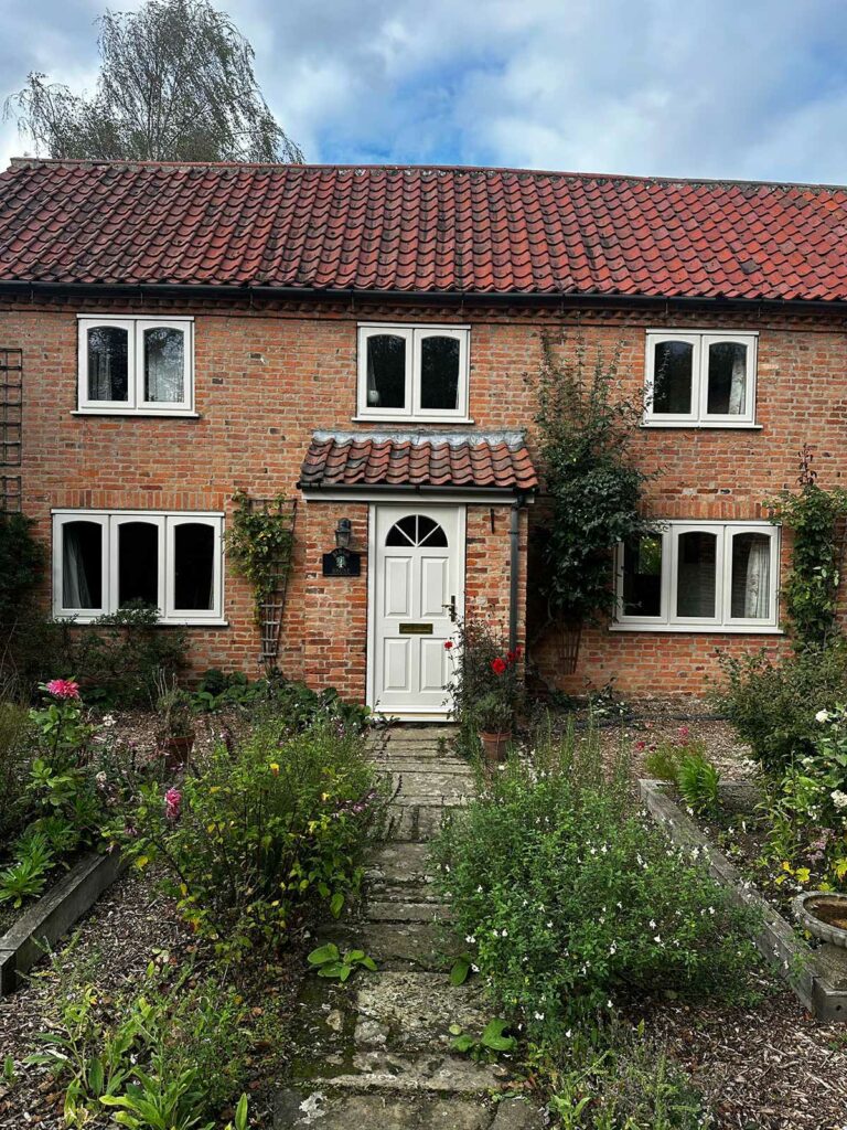 stormproof casement windows on a red brick country home