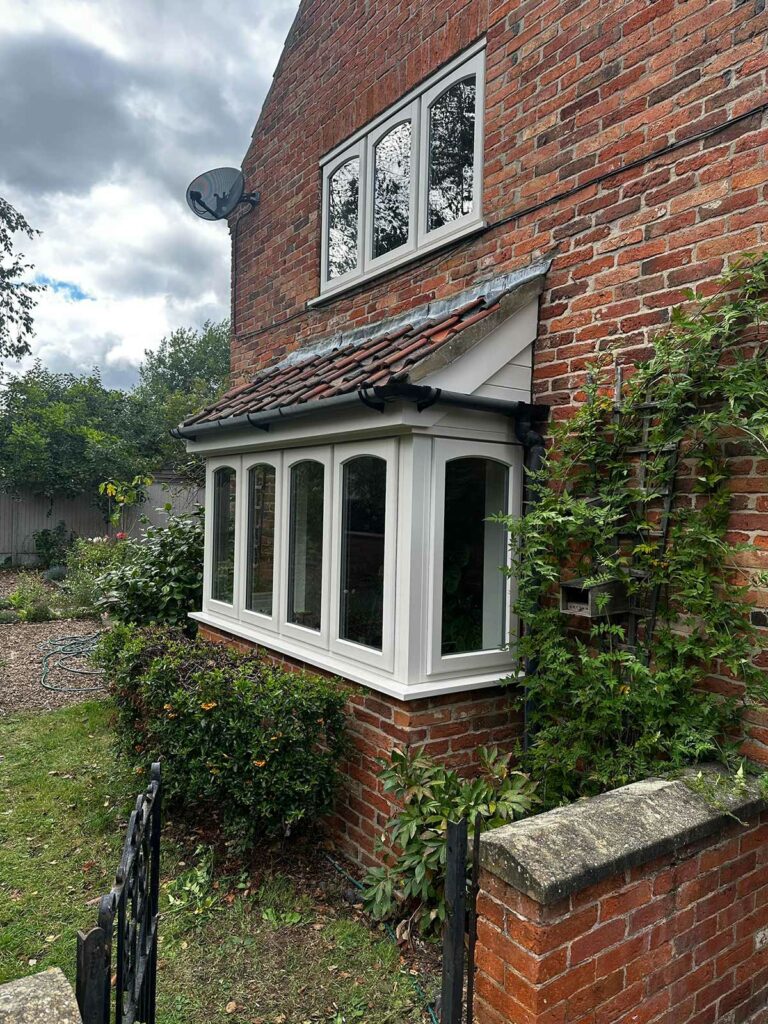 stormproof casement windows on a red brick country home