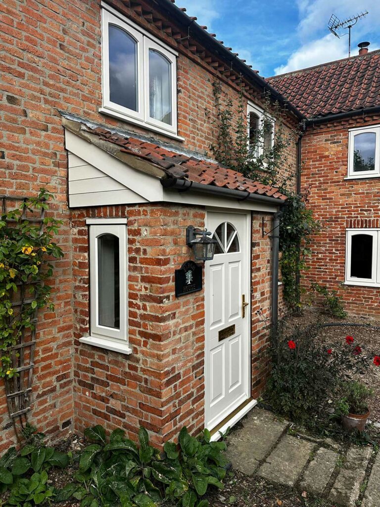 stormproof casement windows on a red brick country home