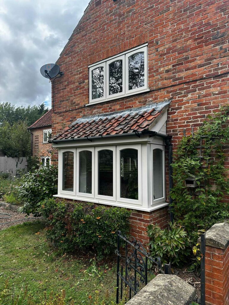 stormproof casement windows on a red brick country home