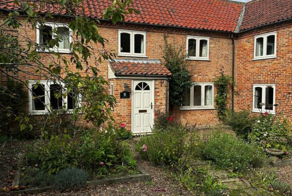 stormproof casement windows on a red brick country home