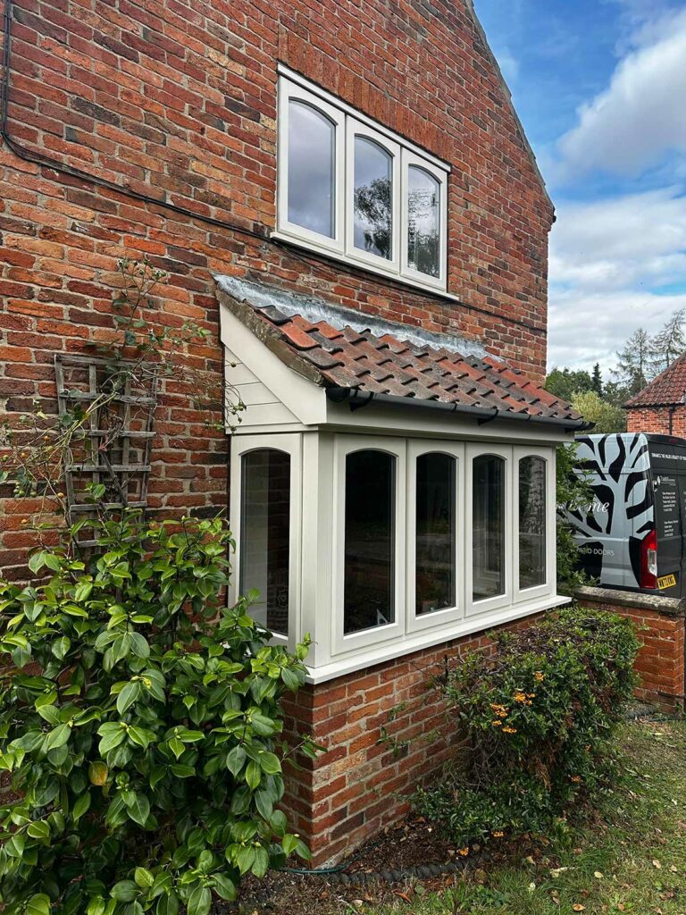 stormproof casement windows on a red brick country home