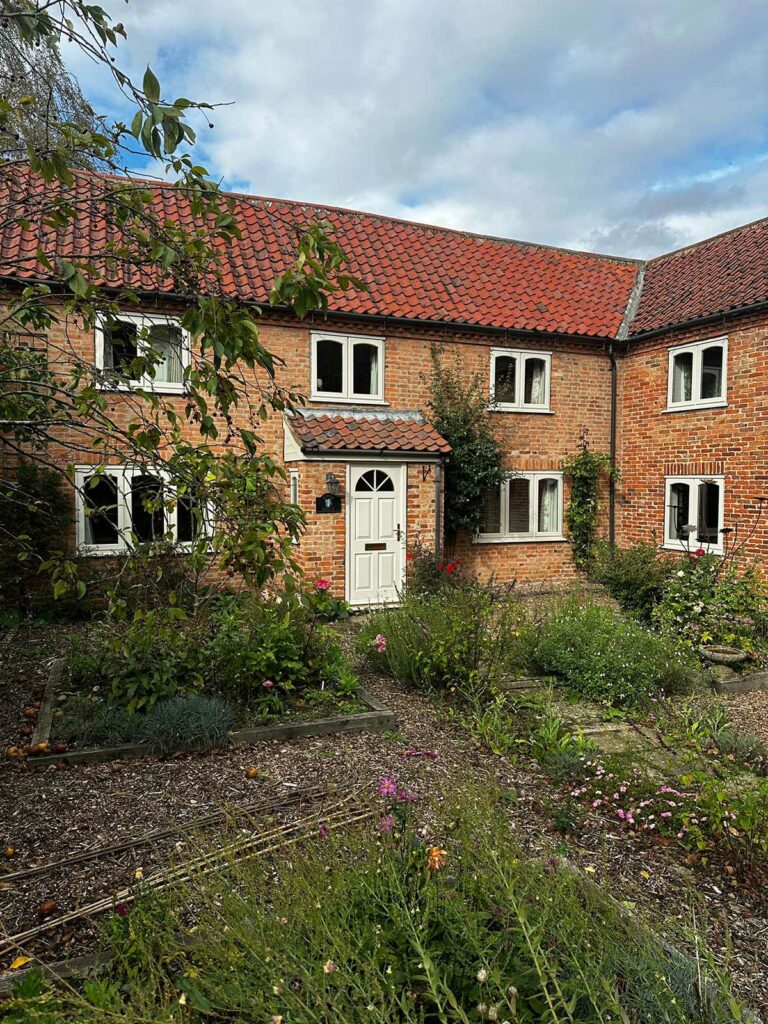 stormproof casement windows on a red brick country home