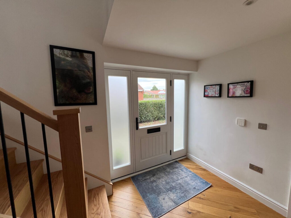 white timber windows and doors on a traditional red brick home