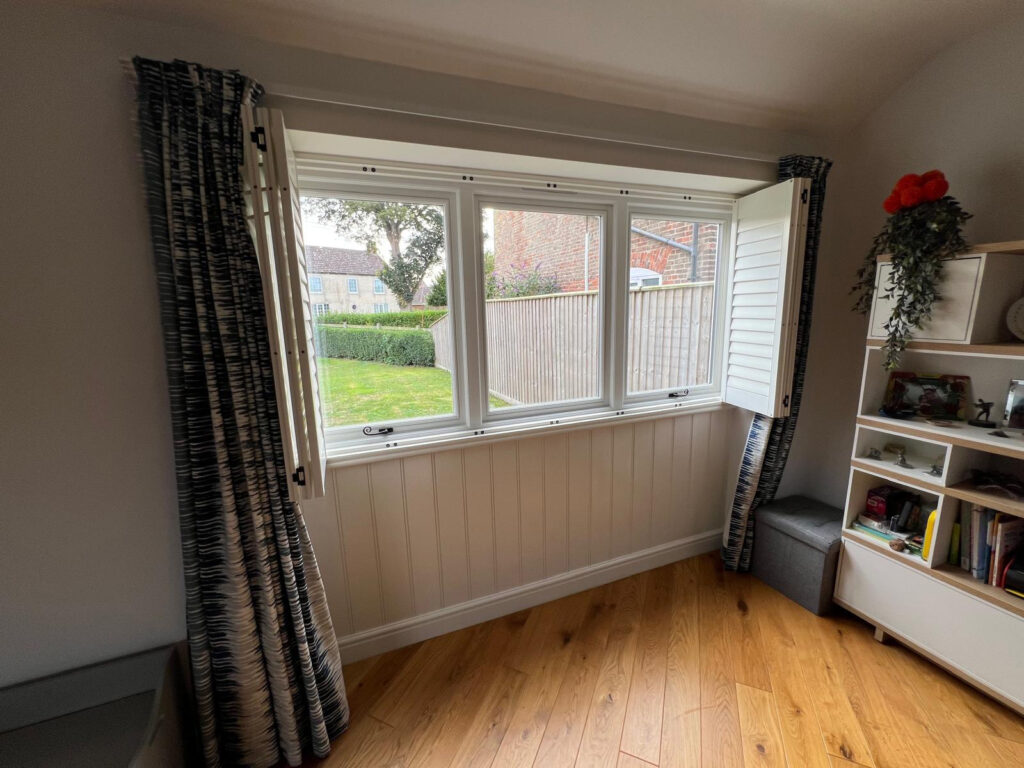 white timber windows and doors on a traditional red brick home