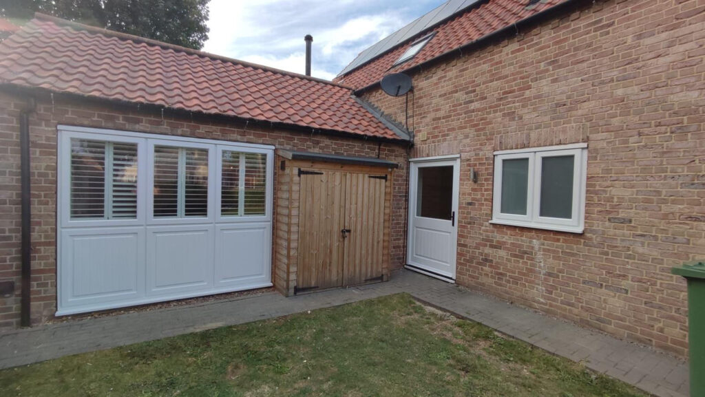 white timber windows and doors on a traditional red brick home