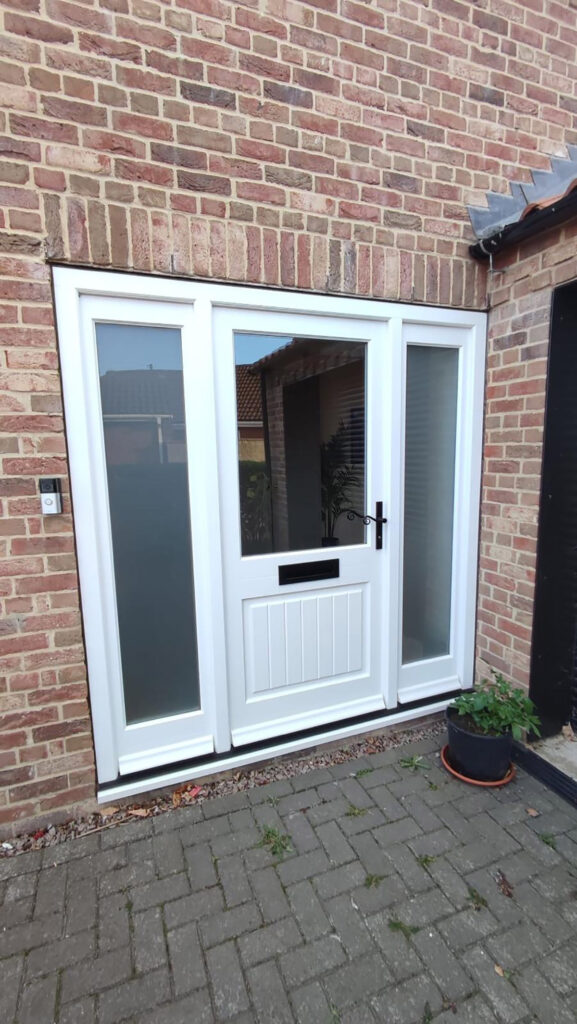 white timber windows and doors on a traditional red brick home