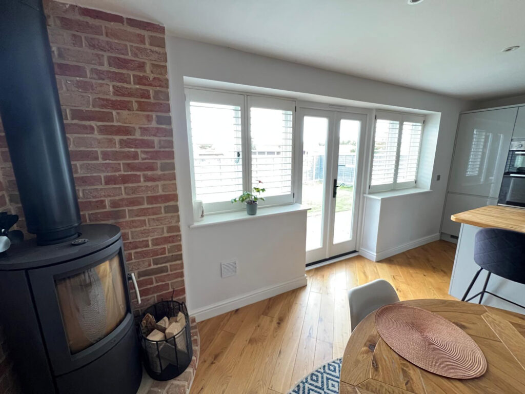 white timber windows and doors on a traditional red brick home