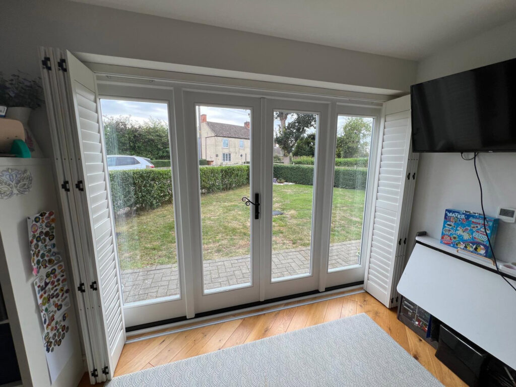 white timber windows and doors on a traditional red brick home