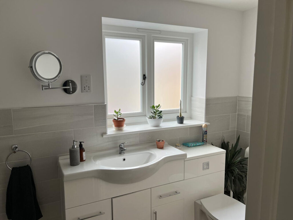 white timber windows and doors on a traditional red brick home