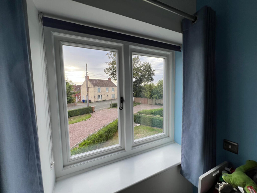 white timber windows and doors on a traditional red brick home