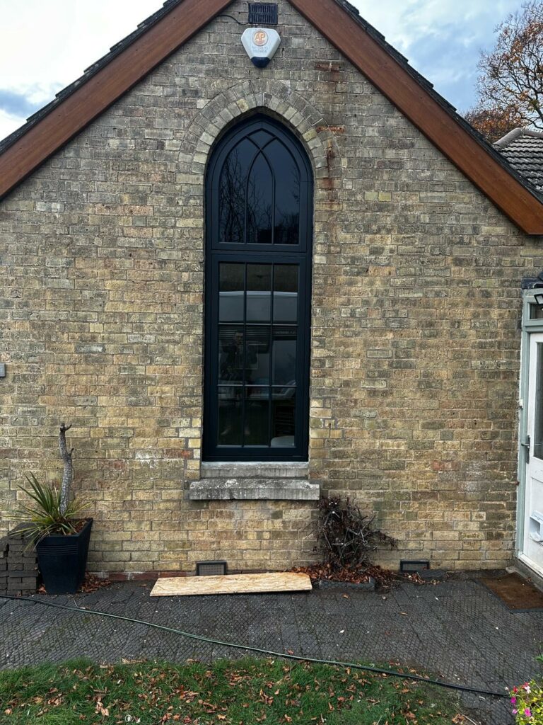 a large, arched gothic style window on the side of a building