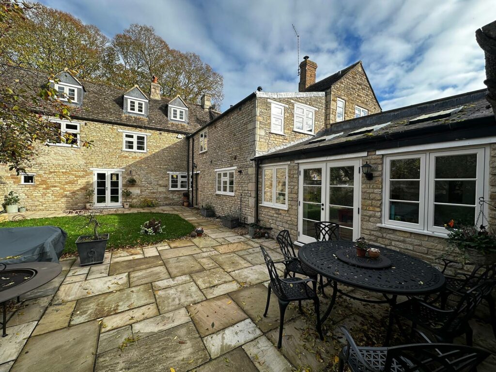 a large rural home with a generously sized patio