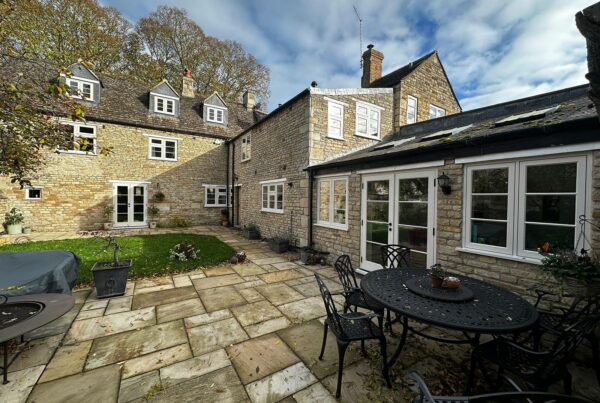 a large rural home with a generously sized patio